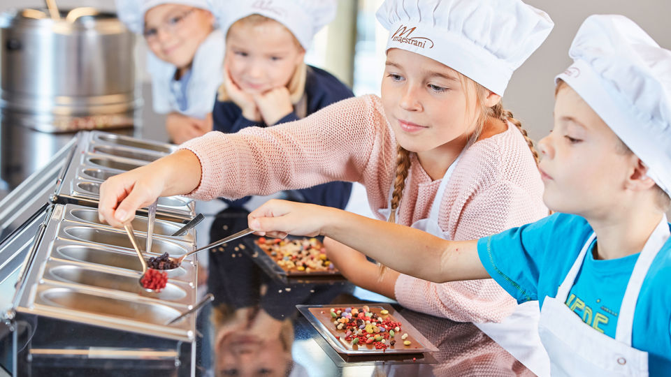 Kinder stellen im Chocolarium ihre eigene Schokoladentafel zusammen